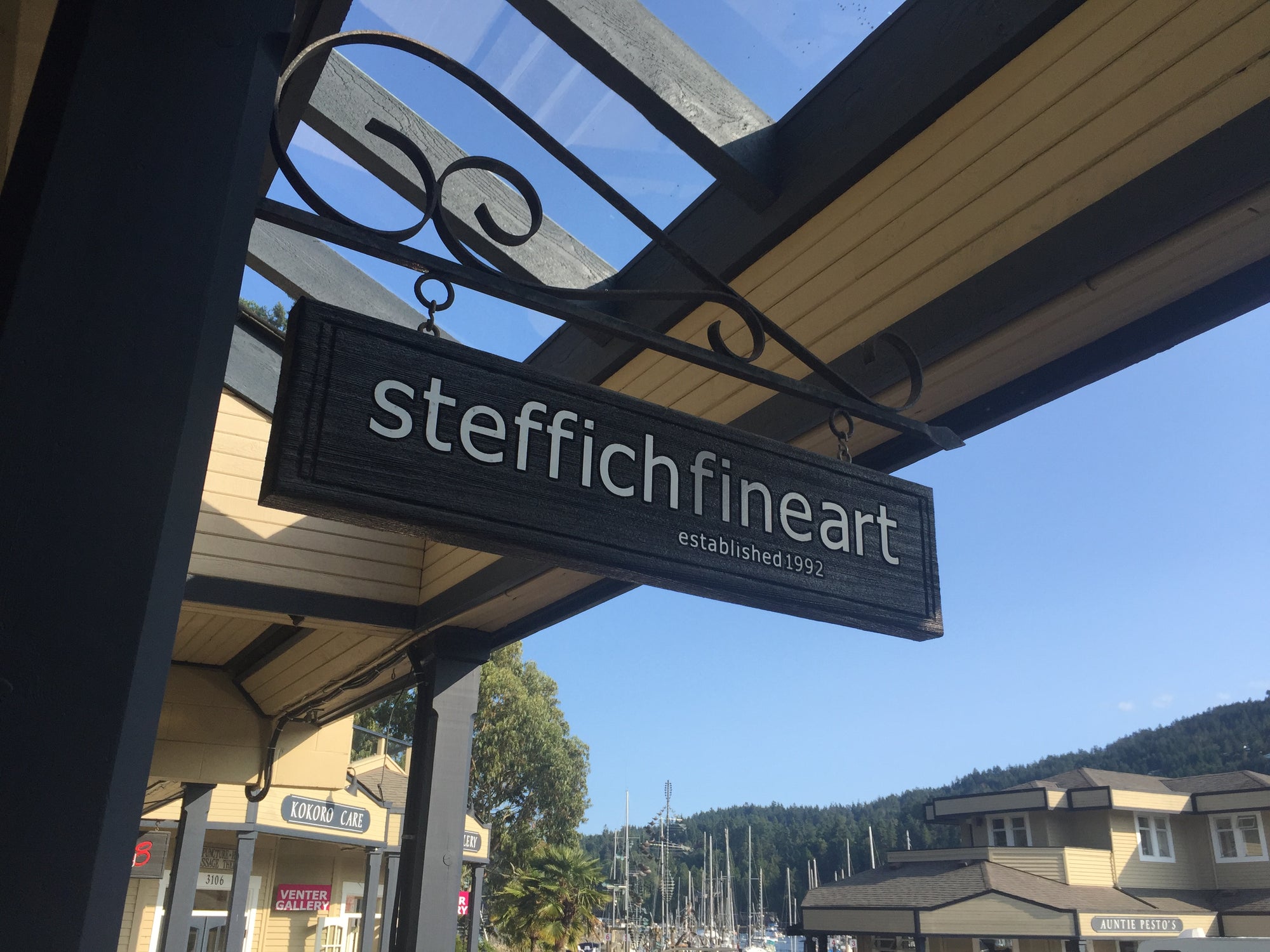 Steffich Fine Art sign outside on a blue sky day on salt spring island in British Columbia.