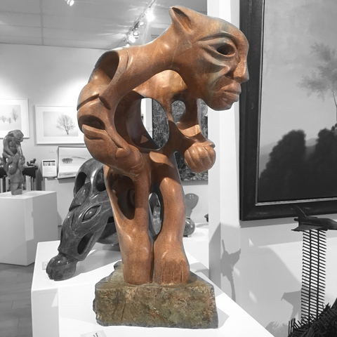 soap stone sculpture by abraham ruben of a shaman with intertwined helpers