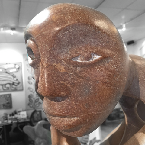 soap stone sculpture by abraham ruben of a shaman with intertwined helpers face