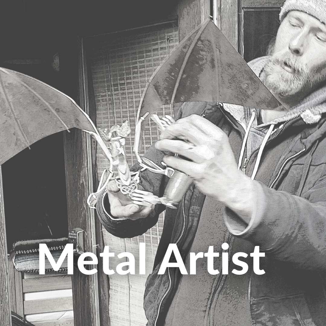 Photo of Saturna Artist holding his Dragon Sculpture made out of repurposed cutlery