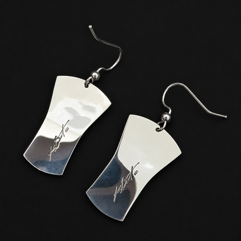 This Grizzly Bear Clan silver earrings by Kolten Khasalus Grant features a finely carved Northwest Coast design in a compact wearable sculptural format. 