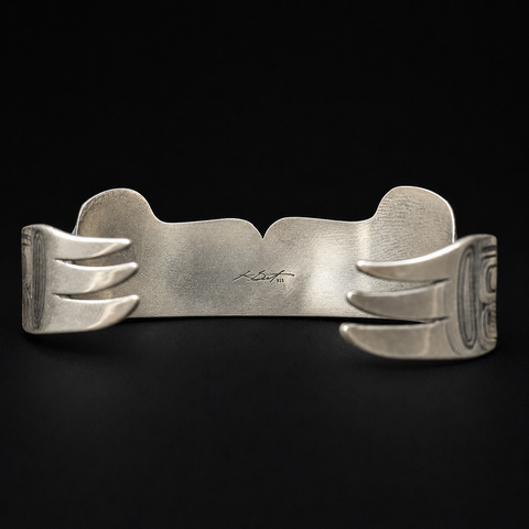 This sterling silver Hummingbird and the Flower People cuff bracelet by Kolten Khasalus Grant carries a flowing Northwest Coast design across a substantial wearable form back.