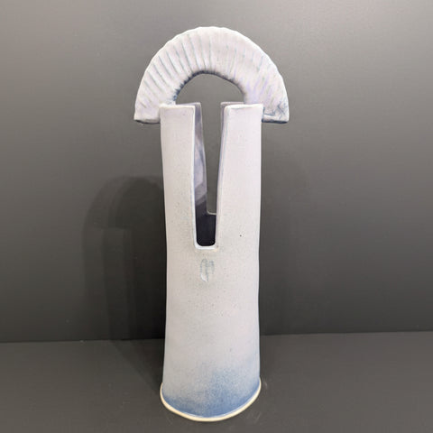 Cylindrical ceramic lavender vase with a wide neck and flared top on a gray background