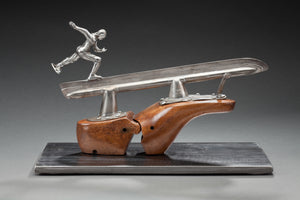 Peter McFarlane Reused Scrap Metal Sculpture with reused old skate and a skater skating on the upsidedown skate