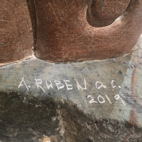 soap stone sculpture by abraham ruben of a shaman with intertwined helpers signature